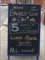  ?? GLENN GRIFFITH — DIGITAL FIRST MEDIA ?? A sandwich board outside Psychedeli­catessen with the special menu offerings for Saturday’s National Bagels and Lox Day.