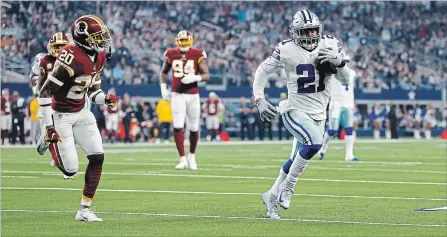  ?? RON JENKINS THE ASSOCIATED PRESS ?? Dallas Cowboys running back Ezekiel Elliott, right, scampers past Washington’s Ha Ha Clinton-Dix on his way to a touchdown on Thursday. After scoring, Elliott dropped $21 into a giant Salvation Army red kettle behind the end zone. The cash was handed to him by a team photograph­er.