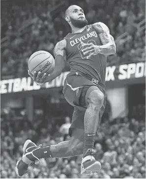  ??  ?? LeBron James goes up for a dunk against the Nets during the Cavaliers’ current seven-game winning streak. KEN BLAZE/USA TODAY SPORTS