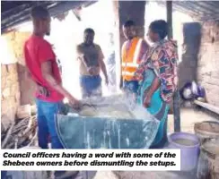  ?? ?? Council officers having a word with some of the Shebeen owners before dismuntlin­g the setups.