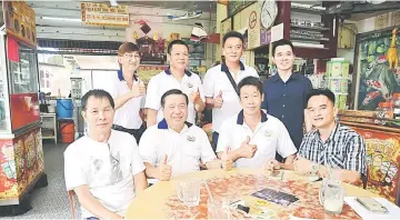  ??  ?? Wong and event organising chairman Michael Wong Siang Tiong (seated second and third left respective­ly) with other club members.