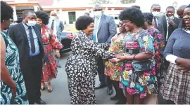  ?? ?? Angel of Hope founder and patron First Lady Dr Auxillia Mnangagwa shares a lighter moment with guests who were dressed in yesteryear fashion style including the Afro hairstyle during the fundraisin­g dinner at State House on Friday. Pictures by John Manzongo