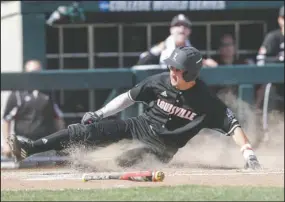  ?? The Associated Press ?? SLIDING IN AT HOME: Louisville’s Ryan Summers scores at home on a single by Colby Fitch, who later advanced to second base on an error, in the eighth inning of a College World Series game against Texas A&M in Omaha, Neb., Sunday. Louisville won 8-4.