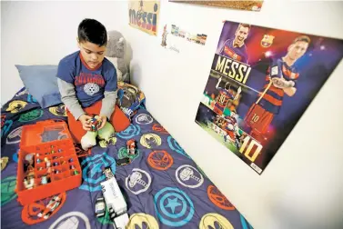  ?? PHOTOS BY LUIS SÁNCHEZ SATURNO/THE NEW MEXICAN ?? Nine-year-old Juan Jaret Torres, who was born in the U.S., plays with a Rubik’s cube Saturday at his Santa Fe home. Legal experts recommend parents at risk of deportatio­n designate power of attorney for a guardian and have legal documents in place.