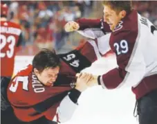  ?? Ross D. Franklin, The Associated Press ?? The Avalanche’s Nathan MacKinnon tries to land a punch on Coyotes right winger Josh Archibald during their fight in Saturday’s game in Phoenix.