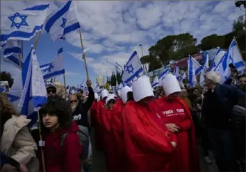  ?? Ohad Zwigenberg/Associated Press ?? Thousands of Israelis protest against plans by Prime Minister Benjamin Netanyahu’s new government to overhaul the judicial system on Monday outside the Knesset, Israel’s parliament, in Jerusalem.