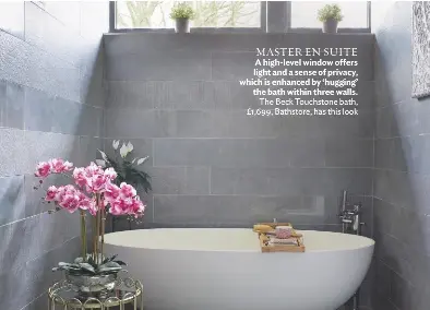  ??  ?? MASTER EN SUITE A high-level window offers light and a sense of privacy, which is enhanced by ‘hugging’ the bath within three walls. The Beck Touchstone bath, £1,699, Bathstore, has this look