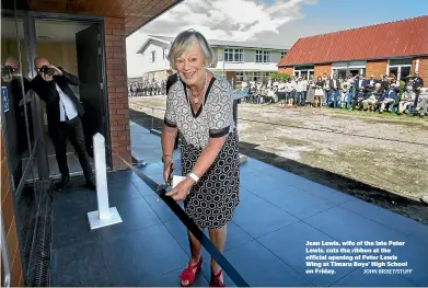  ?? JOHN BISSET/STUFF ?? Jean Lewis, wife of the late Peter Lewis, cuts the ribbon at the official opening of Peter Lewis Wing at Timaru Boys’ High School on Friday.