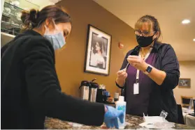  ??  ?? Pharmacist Mai Baltazar (left) and registered nurse Debbie Outcalt prepare doses of the COVID19 vaccine for residents at Oakmont of Montecito.