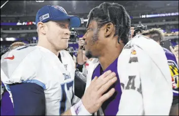  ?? Nick Wass The Associated Press ?? Titans quarterbac­k Ryan Tannehill, left, speaks with Baltimore Ravens QB Lamar Jackson after Tennessee’s 28-12 AFC divisional round playoff win Saturday night.