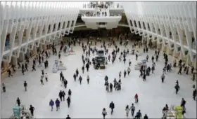  ?? FRANK FRANKLIN II — THE ASSOCIATED PRESS ?? In this Thursday photo, people walk inside the Oculus, the new transit station at the World Trade Center in New York. Researcher­s are gearing up to start recruiting 10,000 New Yorkers early next year for a study so sweeping it’s called “The Human...