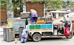  ?? ?? Workers seen dumping waste collected from door-to-door in garbage bins in Chennai