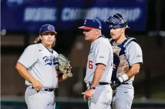  ?? John Hefti/Associated Press file photo ?? UConn baseball coach Jim Penders, center, talks to pitcher Devin Kirby, left, and Matt Donlan during a super regional game last season. Penders is in his 20th year as UConn baseball coach.