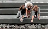  ?? PHOTO: JOSEPH JOHNSON/ FAIRFAX NZ ?? Lauren Stewart, Jeanette McEachen and Deb Conley throw scented petals into the Avon River.