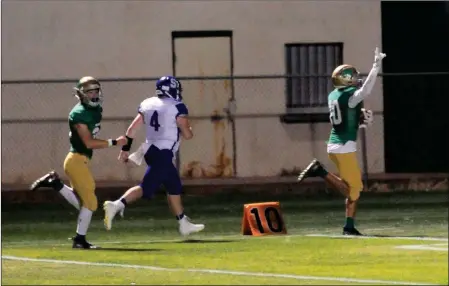  ?? Buy these photos at YumaSun.com PHOTOS BY BRIAN FOGG/YUMA SUN ?? YUMA CATHOLIC SENIOR linebacker Randal Voutt scores on an intercepti­on return for a touchdown in the second quarter of Friday night’s 65-28 win over Safford at Ricky Gwynn Stadium. Voutt returned two intercepti­ons for touchdowns in the game.