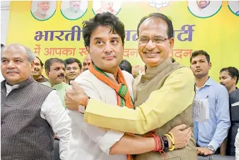  ??  ?? BJP leader Jyotiradit­ya Scindia being felicitate­d by party leader Shivraj Singh Chauhan in Bhopal on Thursday. Scindia said he considers himself fortunate that the BJP accepted him in the party and assured party workers that he will work wholeheart­edly for them.