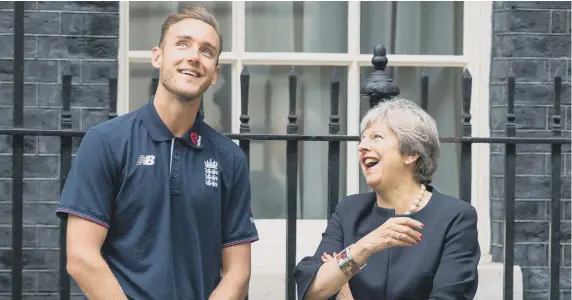  ?? ?? Prime Minister Theresa May speaks to England bowler Stuart Broad as they watch a game of street cricket on Downing Street yesterday.