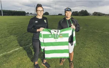  ?? KAVINDA HERATH/SOUTHLAND TIMES ?? Riverton Rugby Club 150th jubilee committee members, secretary Rachel McKay and president Rodney Lonneker with a special edition rugby jersey made for the club’s celebratio­ns from April 25-27.