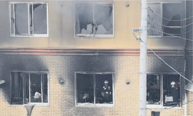  ?? PICTURE: JIJI PRESS ?? 0 Rescue teams and firefighte­rs are still searching the three-storey animation studio which has produced a string of hit anime films