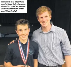  ??  ?? Ioan Lloyd, then a Year Nine pupil at Ysgol Gyfun Gymraeg Glantaf in Cardiff, receives an award from former Glantaf pupil Rhys Patchell