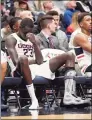  ?? Jessica Hill / Associated Press ?? UConn’s Akok Akok (23) on the bench with a boot on his left foot after suffering an Achilles’ tendon injury on Feb. 16, 2020 in Hartford.