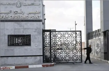  ?? PICTURE: AP ?? A Hamas security officer closes the main entrance gate of the Rafah border crossing in the Gaza Strip on Tuesday. A Palestinia­n official said Gaza’s crossing with Egypt will operate under an internatio­nal agreement long opposed by the territory’s...