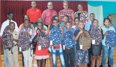  ?? CONTRIBUTE­D ?? The 16 students who received grants and educationa­l gifts from Lloyd B. Smith, member of parliament for St James Central, with gifts they received at a luncheon at the Internatio­nal University of the Caribbean in Montego Bay. Also there to support the...