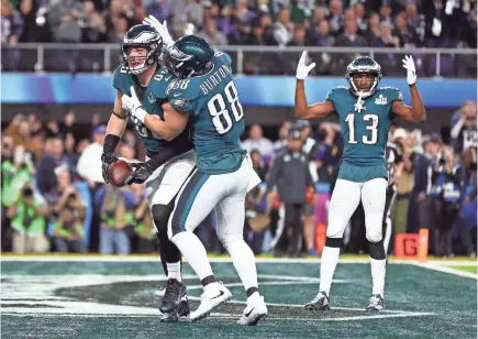  ??  ?? Zach Ertz (86) celebrates with teammates after scoring a TD in the Eagles’ Super Bowl win.