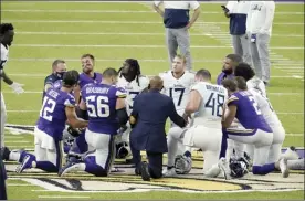  ?? AP photo ?? Tennessee Titans and Minnesota Vikings players meet at midfield following an NFL football game, Sunday in Minneapoli­s. Tennessee won 31-30. The NFL says the Titans and the Vikings are suspending in-person activities after the Titans had three players test positive for the coronaviru­s, along with five other personnel.