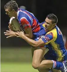  ?? PHOTO: KEVIN FARMER ?? COME HERE: TRL All Stars player Billy Jackwitz is tackled in last year’s TRL All Stars v South-West Emus pre-season match at Clive Berghofer Stadium.