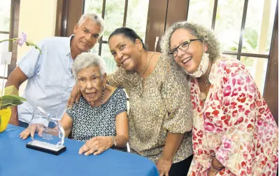  ?? ?? Carmen Robertson Brown (second left) is surrounded by her family: Michael Forrester (left), Marguerite Forrester (second right), and Jean Moss-Solomom during a small tea party held in her honour.