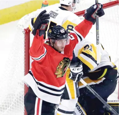  ?? | NAM Y. HUH/ AP ?? Brandon Saad celebrates after scoring his first goal in the first period Thursday night against the Penguins.