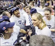  ?? Eric Gay / AP ?? UConn players carry coach Geno Auriemma off the floor after winning the NCAA Tournament championsh­ip game against Stamford in 2010.