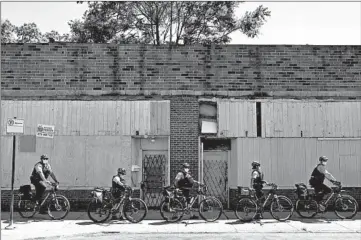  ?? TERRENCE ANTONIO JAMES/CHICAGO TRIBUNE ?? Chicago police ride near marchers on West 16th Street in Chicago on June 12.