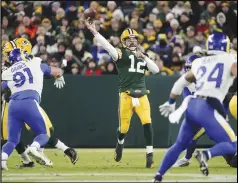  ?? Associated Press ?? Green Bay Packers quarterbac­k Aaron Rodgers (12) throws a pass during the first half against the Los Angeles Rams on Sunday in Green Bay, Wis. The Packers beat the Rams 36-28.