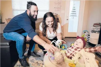  ?? DAVID J. PHILLIP/AP ?? Kelsey Wright, seen with her spouse and 4-month-old in Montgomery, Texas, has chosen adoption before.