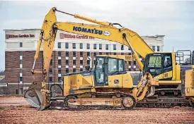  ??  ?? Constructi­on equipment sits at the proposed site of a Crest Foods directly west of the new Hilton Garden Inn.