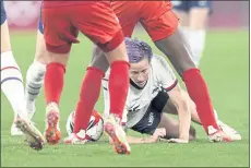  ??  ?? The United States’ Megan Rapinoe falls to the ground during the match against Canada.