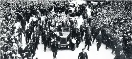  ??  ?? > The celebratio­n parade arrives at City Hall in Cathays, Cardiff