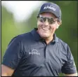  ?? Associated Press ?? FEELING GOOD — Phil Mickelson smiles after finishing the round on the ninth hole during the first round of the Wells Fargo Championsh­ip at Quail Hollow Club on Thursday in Charlotte, N.C. Mickelson took the lead with a 64.