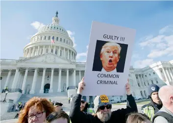  ?? — AP ?? Demonstrat­ors protest outside the Capitol during the impeachmen­t trial of President Donald Trump in Washington