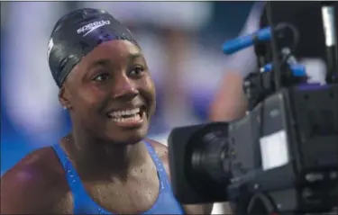  ?? PETR DAVID JOSEK — THE ASSOCIATED PRESS ?? United States’ Simone Manuel smiles after winning the gold medal in the women’s 100-meter freestyle final during the World Aquatics Championsh­ips in Budapest, Hungary, on July 28.