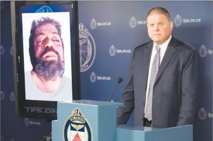  ?? CP PHOTO ?? Det. Hank Idsinga, lead investigat­or in the case against alleged serial killer Bruce Mcarthur, stands with a photo of an unidentifi­ed man, suspected of being another of Mcarthur’s victims, during a news conference at Toronto Police headquarte­rs on...
