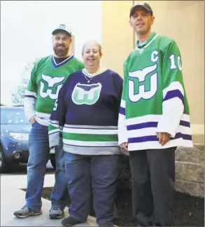  ?? Pat Eaton-Robb / Associated Press ?? Hartford Whalers Booster Club members, from left, Scott St. Laurent, Joanne Coressa and Dan Narvesen pose outside a Manchester restaurant on Thursday where they gathered to watch Game 1 of the NHL Eastern Conference playoff series between the Carolina Hurricanes and the Boston Bruins.