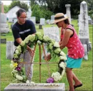  ?? CHARLES PRITCHARD — ONEIDA DAILY DISPATCH ?? Heather Bright, left, and Lolita Smith-Dorsett place a wreath on Gerrit Smith’s headstone for Emancipati­on Day on Saturday, Aug. 4, 2018.