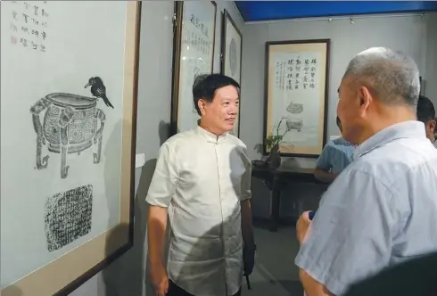  ?? PHOTOS PROVIDED TO CHINA DAILY ?? Jia Wenzhong shows his rubbings of ancient bronze ware and other relics at an exhibition in Beijing’s Prince Kung’s Mansion.