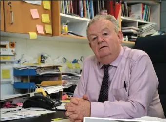  ??  ?? Retiring Pobalscoil Chorca Dhuibhne Principal Pádraig Firtéar at his desk on Monday. RIGHT: Pádraig at school with his grandson Pádraig.