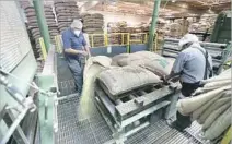  ?? Photograph­s by Allen J. Schaben Los Angeles Times ?? WORKERS at the Vernon factory pour out bags of coffee beans for cleaning. The company has opened its first coffeehous­e.