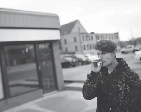  ?? DAX MELMER ?? George Montpetit, a drug user who has been homeless for the last two years, smokes a cigarette in front of the proposed safe injection site in the 700 block of Pelissier Street on Friday. “If I had to, I would come here. It’s safer than the streets,”...