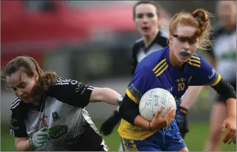  ??  ?? Lisa Casey, who scored a penalty for Sligo, with Roscommon’s Louise Brady.